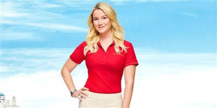 Hannah Ferrier in red polo smiling against a blue background