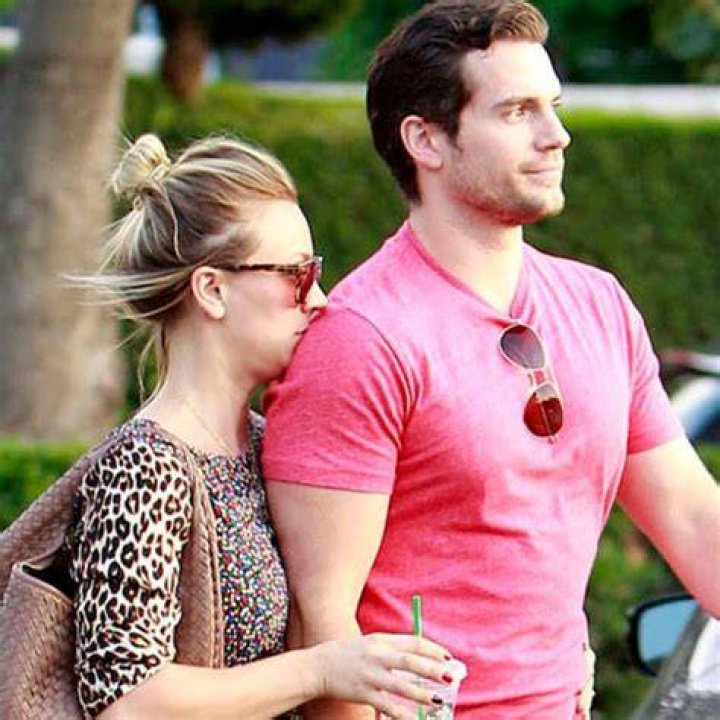 Henry Cavill and Kaley Cuoco are walking together.