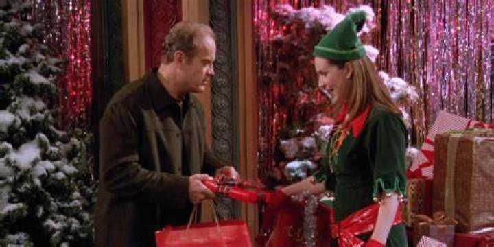 Roz, dressed as an elf, chats with Dean Cain's store Santa Claus in Frasier: We Two Kings