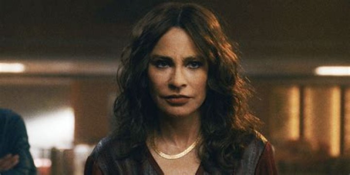Sofia Vergara as Griselda Blanco folds her arms as she sits on a porch in front of palm trees in Netflix's Griselda