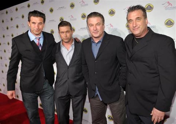 The Baldwin family is posing for a picture on the red carpet. 